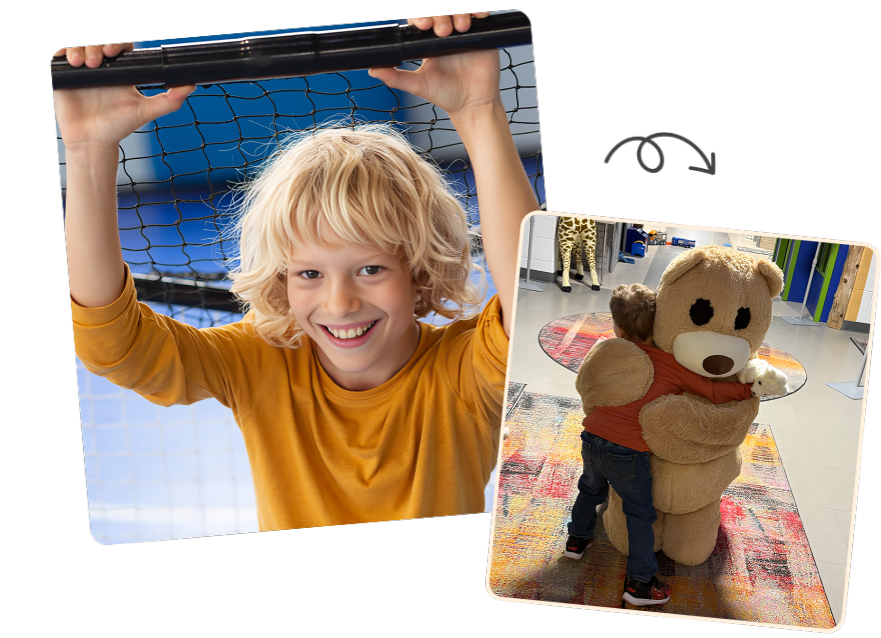 A smiling boy in a yellow shirt holding onto a bar.